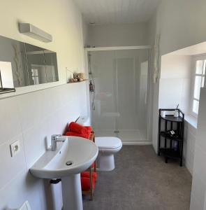 a bathroom with a toilet and a sink and a shower at Maison de charme à 2km de la mer in Kerlouan