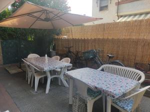 a table and chairs with an umbrella on a patio at apartment from Ire e Ale in Torre del Lago Puccini