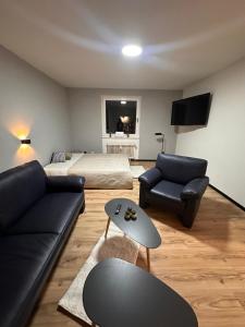 a living room with a couch and a bed at Wohnung für Monteure mit Balkon in Celle! in Celle