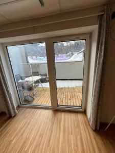 a room with a sliding glass door with a deck at Klausners Ferienwohnung in Neustift im Stubaital