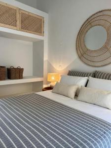 a bedroom with a large bed and a mirror at Herdade d' Amoreira Lavanda Villa in Aljezur +136 photos