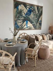 a living room with a couch and a table and chairs at Herdade d' Amoreira Lavanda Villa in Aljezur