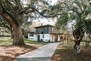 a house with a tree and a sidewalk at 5 Bedroom home near Parris Island, MCAS, Downtown Beaufort in Beaufort