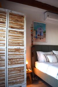a bedroom with a bed and a large wooden door at House with sea view in the old town of Alicante in Alicante