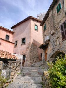 an old stone building with stairs in front of it at La Finestra tra le Stelle in Anguillara Sabazia