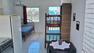 a living room with a bunk bed and a table at Residencial Caiobá II in Matinhos