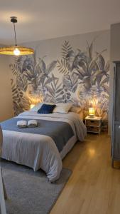 a bedroom with a large bed with a mural at Blue Cottage - Charme & Verdure in Saint-Martin-lez-Tatinghem