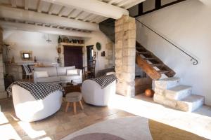 a living room with white furniture and a staircase at Mas des Eaux Claires Arles Camargue in Saint-Gilles +15 photos