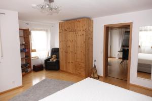 a bedroom with a large wooden cabinet in a room at Fewo Anna - ruhig gelegen, mitten in der Natur, unmittelbar am Neckarsteig in Neckarsteinach