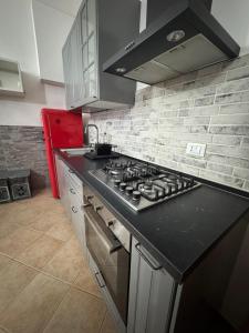 a kitchen with a black counter top with a stove at Appartamento A&S-Centro Argenta in Argenta +2 photos