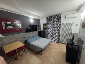 a bedroom with a bed and a table in a room at Home 07 - Centro Argenta in Argenta