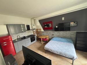 a room with a kitchen with a bed in it at Home 07 - Centro Argenta in Argenta