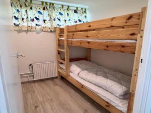 a bunk bed in a room with a bunk bed in a room at Pet-friendly bungalow near Beach in Sint Maartenszee