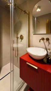 a bathroom with a white sink and a shower at Apartament Acaia Old Town in Gdańsk