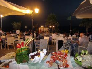 a table with plates of food on top of it at Kefalos Beach Tourist Village in Paphos City +120 photos