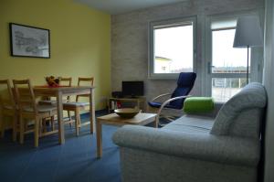 a living room with a couch and a table at FerienhausLychen in Lychen