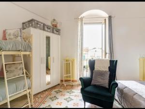 a bedroom with a bed and a chair and a mirror at Casa vacanze San Giovanni nei Sassi in Matera