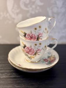 a stack of three tea cups and saucers on a table at Malahide Guest Rooms in Malahide