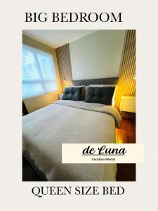 a bedroom with a large bed with a large window at de Luna Vacation Rental in Davao City +14 photos