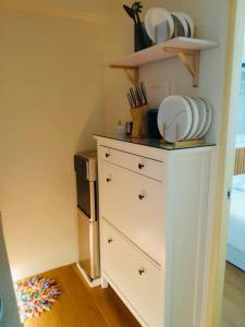 a white dresser with plates on top of it at de Luna Vacation Rental in Davao City