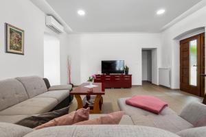 a living room with two couches and a tv at Old Stone Villa Katarina in Nedeščina +36 photos