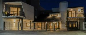 a building with a fence in front of it at La Morada Petit Hotel in Neuquén