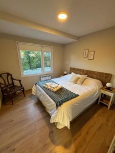a bedroom with a bed with a tray on it at Andalue in San Carlos de Bariloche