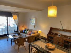 a living room with a couch and a table at Apartamento Port Dénia in Denia