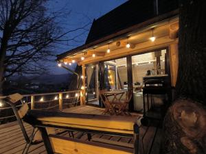 a deck with a bench and lights on it at Cabana A in Şurdeşti