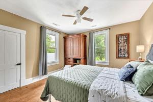 a bedroom with a bed and a ceiling fan at Beit Shalom- House of Peace Family in Siloam Springs
