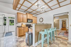 a kitchen with wooden cabinets and blue stools at Beit Shalom- House of Peace Family in Siloam Springs