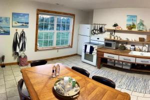 a kitchen with a wooden table and a dining room at The Varnadoe Villa- Farm Stay in Siloam Springs