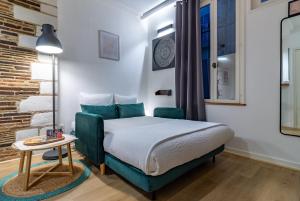 a small bedroom with a bed and a table at La Maison Verte -Hypercentre-confort in Troyes