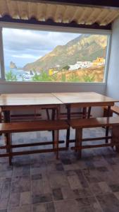 a table in a room with a large window at Casa lucas in Almáciga