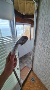 a person holding a shower head in a room at Casa lucas in Almáciga +19 photos