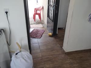 a view of a hallway with a chair and a mirror at Casa vista da montanha in São Thomé das Letras