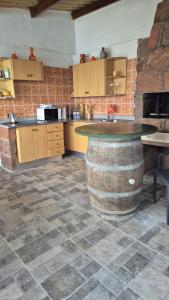 a kitchen with a large barrel table in the middle at Casa lucas in Almáciga