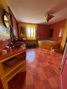 a large bathroom with a tub and a sink at Appartement spacieux à Chenevrey-et-Morogne 160 m² avec terrasse in Chenevrey-et-Morogne