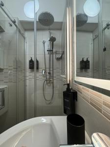 a bathroom with a shower and a bath tub at B&B Terrace09 in Castellana Grotte
