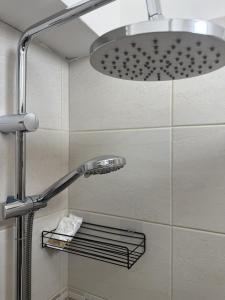 a shower with a shower head in a bathroom at B&B Terrace09 in Castellana Grotte +26 photos