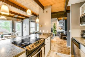 a kitchen with wooden ceilings and a large stove top oven at Cortland Townhome - Walk to Greek Peak Mtn Resort! in Cortland