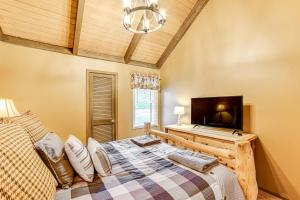a bedroom with a bed and a flat screen tv at Cortland Townhome - Walk to Greek Peak Mtn Resort! in Cortland