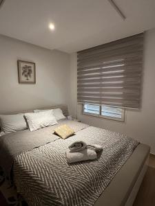 a bedroom with a bed with a towel on it at Appartement Haut standing-coralia,centre ville oujda in Oujda