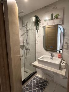 a bathroom with a sink and a shower at Appartement Haut standing-coralia,centre ville oujda in Oujda