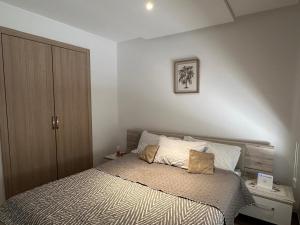 a bedroom with a bed and a wooden cabinet at Appartement Haut standing-coralia,centre ville oujda in Oujda