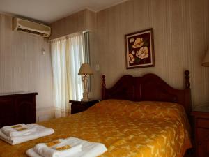 ein Hotelzimmer mit einem Bett mit Handtüchern darauf in der Unterkunft Depto Córdoba centro 4 ambientes in Cordoba + 34 Fotos