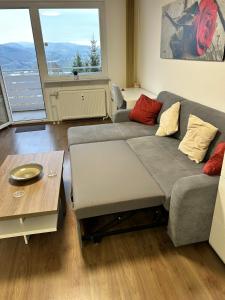 a living room with a couch and a table at Life Modern, Smart Appartment Balkon in Plettenberg