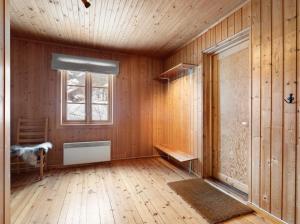 a room with wooden walls and wooden floors and a window at Sirdal Fjellhytte - Holiday home at Sinnes in Haugen