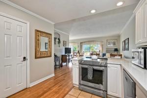 a kitchen with a stove and a living room at La Costa Condo Pool BBQ Gated Parking in Carlsbad