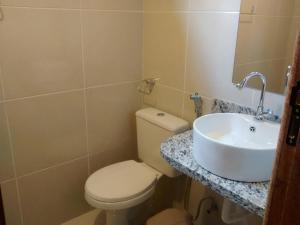 a bathroom with a toilet and a sink at Casa da Jaqueira 03 quartos em Santa Teresa ES in Santa Teresa